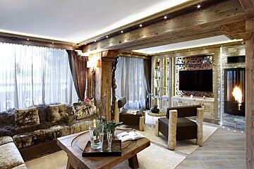 A living room with a wooden table and chairs