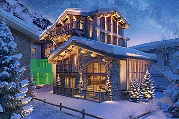A luxurious, snow-covered ski chalet illuminated at night against a starry mountain sky. Warm lights glow from its rustic stone and wood structure.