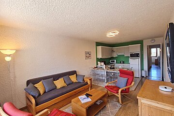 A living room with a couch a chair and a coffee table