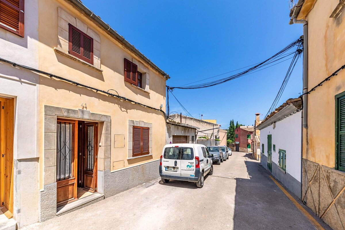 A white van is parked on the side of the road