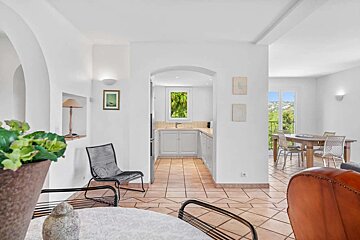 A living room leading to a kitchen and dining room