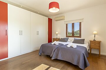 A bedroom with two beds and a window