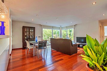 A living room with a couch and a table and chairs