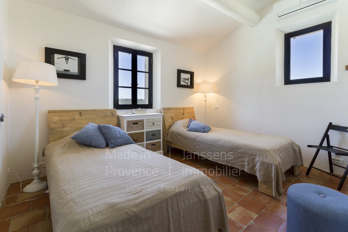 A bedroom with two beds made in provence