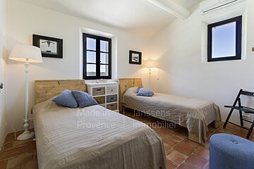 A bedroom with two beds made in provence