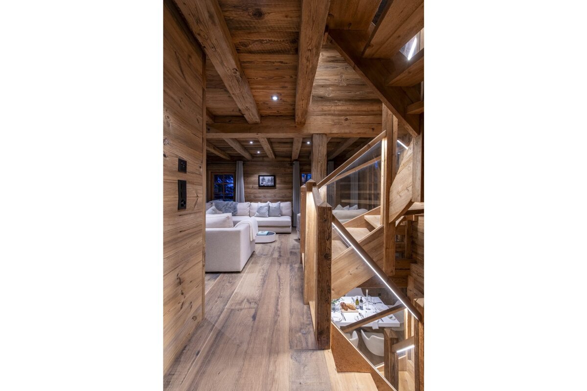 A wooden house with a staircase leading up to the second floor