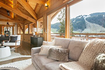 A living room with a view of a ski slope