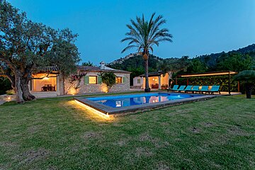 A house with a swimming pool in front of it