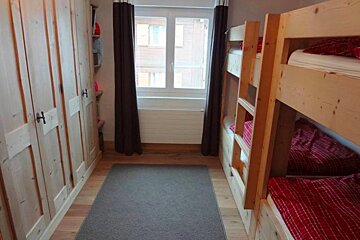 A bedroom with bunk beds and a window