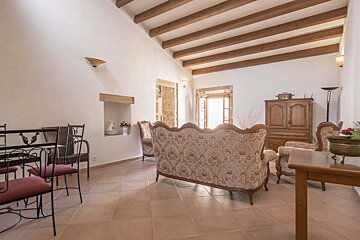 A living room with a couch and chairs and a table