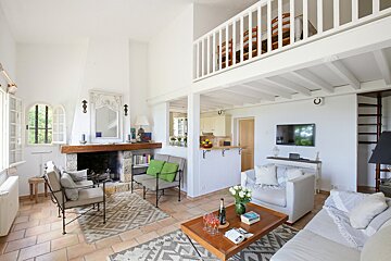 A living room with a couch and chairs and a fireplace