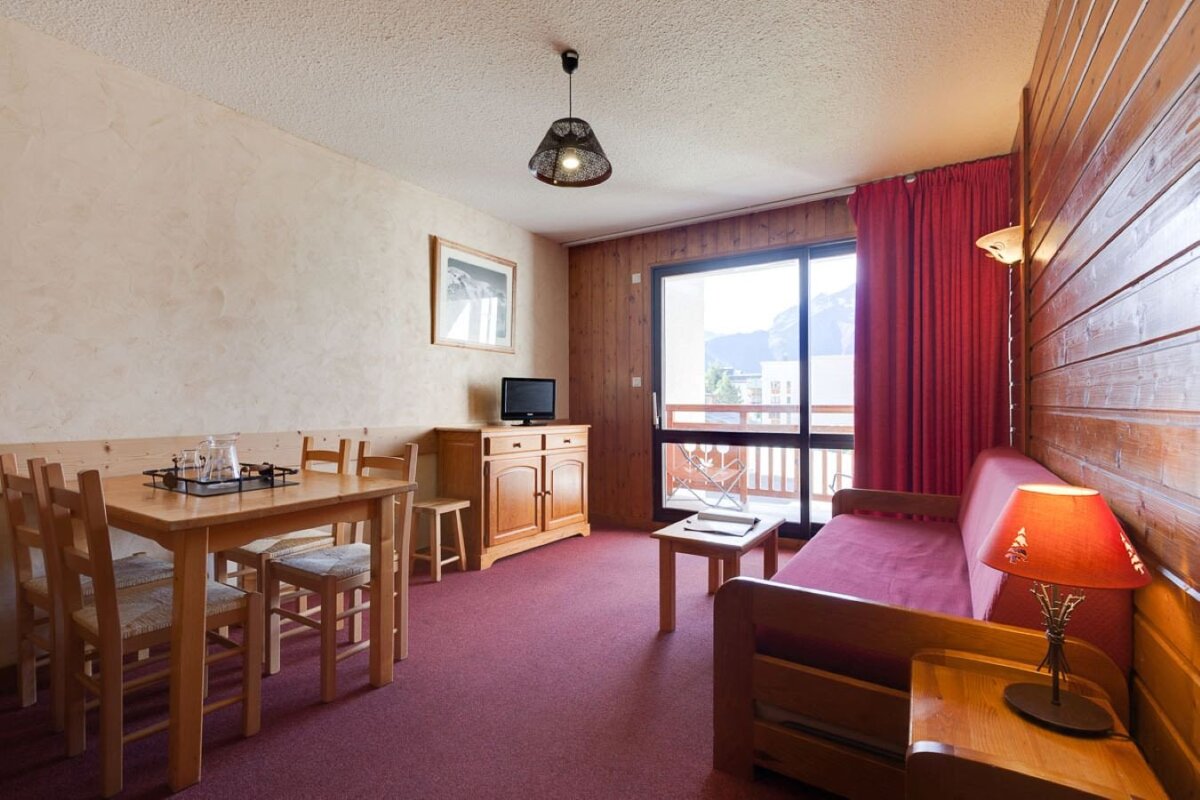 A living room with a couch a table and chairs