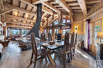 A dining room with a table and chairs and a fireplace