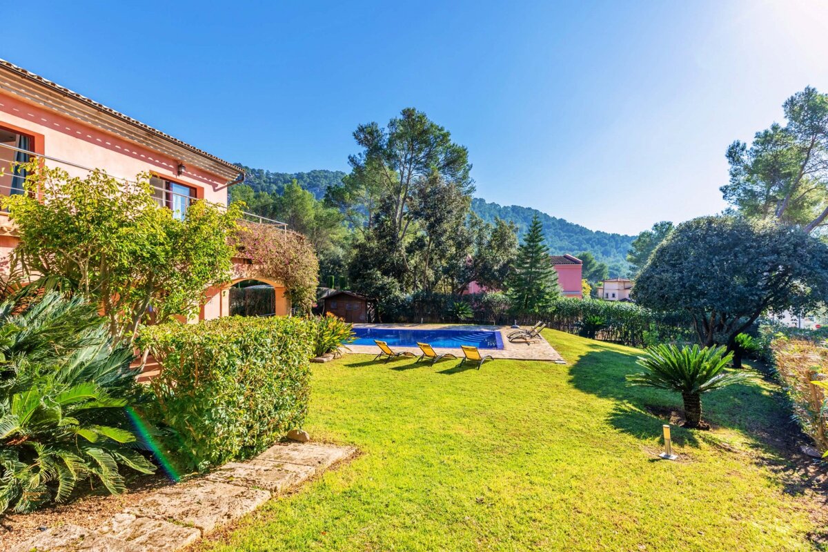 A large house with a swimming pool in the backyard