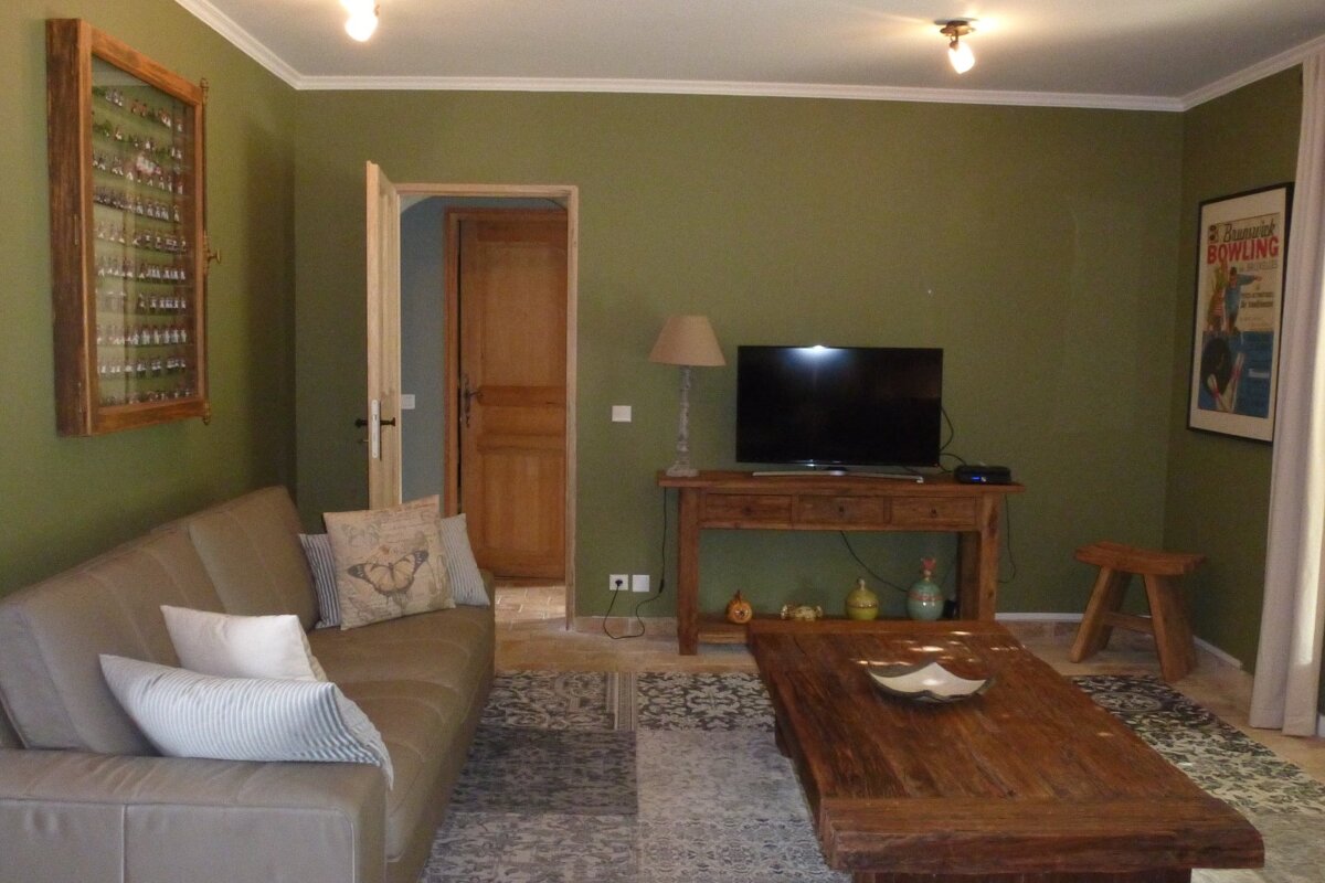 A living room with a couch and a flat screen tv