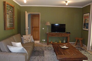 A living room with a couch and a flat screen tv