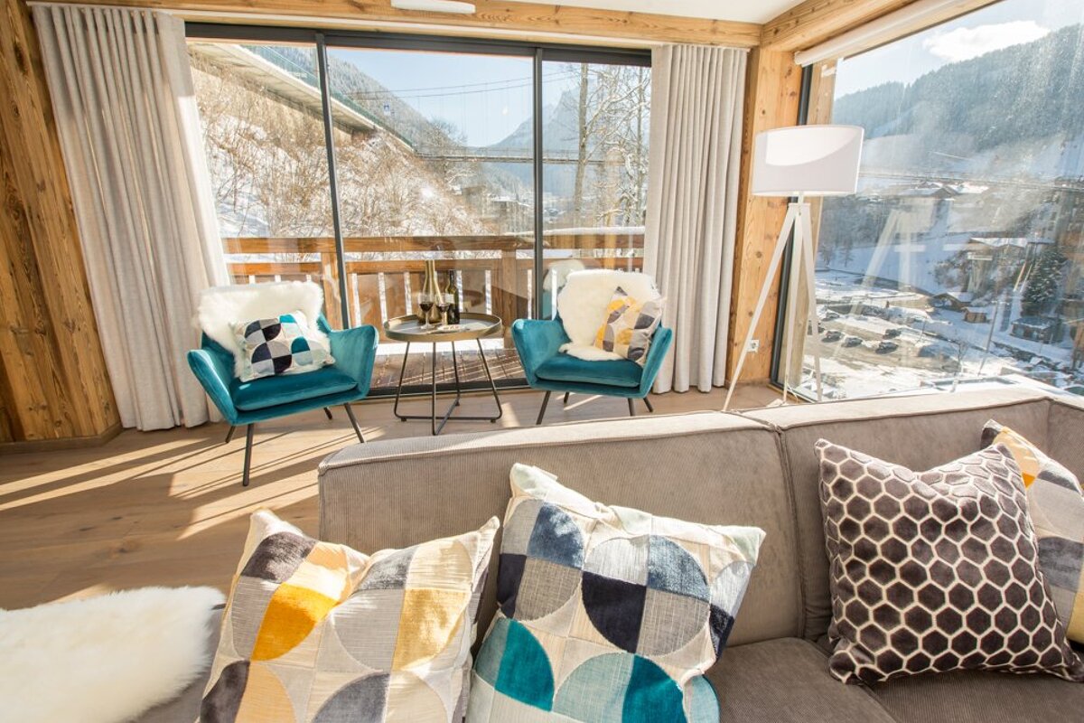 A living room with a couch and two chairs