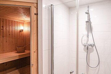 A bathroom with a shower and a sauna
