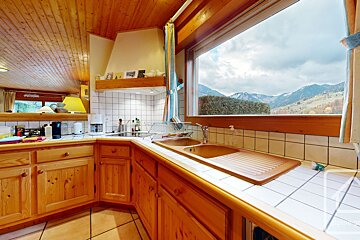 A kitchen with a sink and a view of the mountains