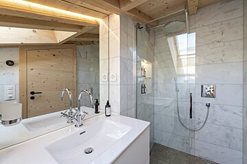 A bathroom with a sink and a walk in shower