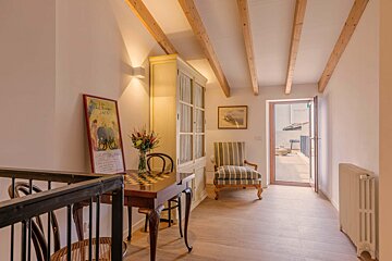 A hallway with a table and chairs and a poster on the wall that says ' l' elephant '