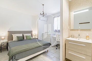 A bathroom with a sink and a bottle of hand soap