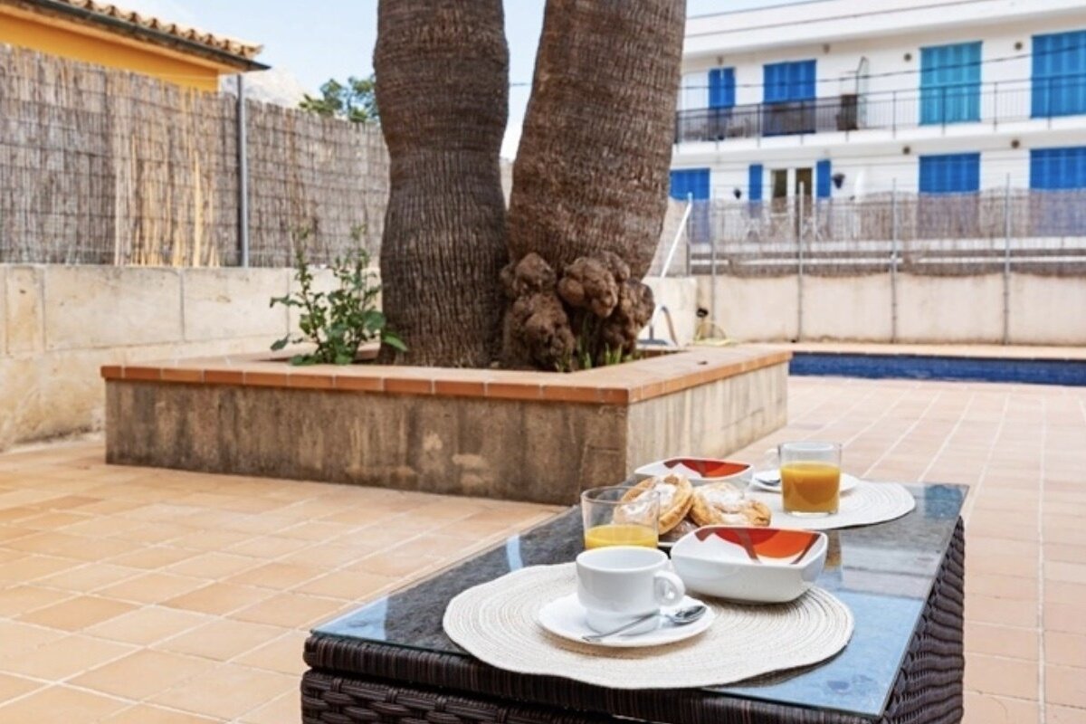 A table with a cup of coffee and orange juice on it
