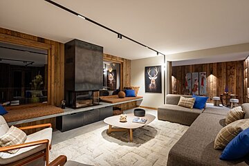 A living room with a deer painting on the wall