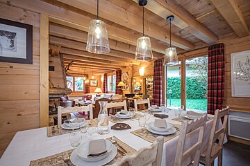 A dining room table with plates and utensils on it