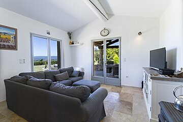 A living room with a couch and a flat screen tv
