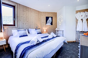 A bedroom with a painting of an owl on the wall
