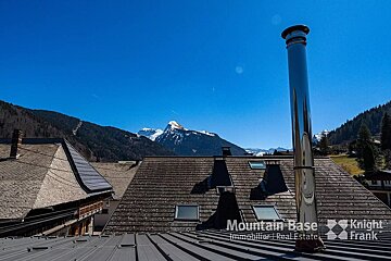 A chimney on the roof of a building that says mountain base