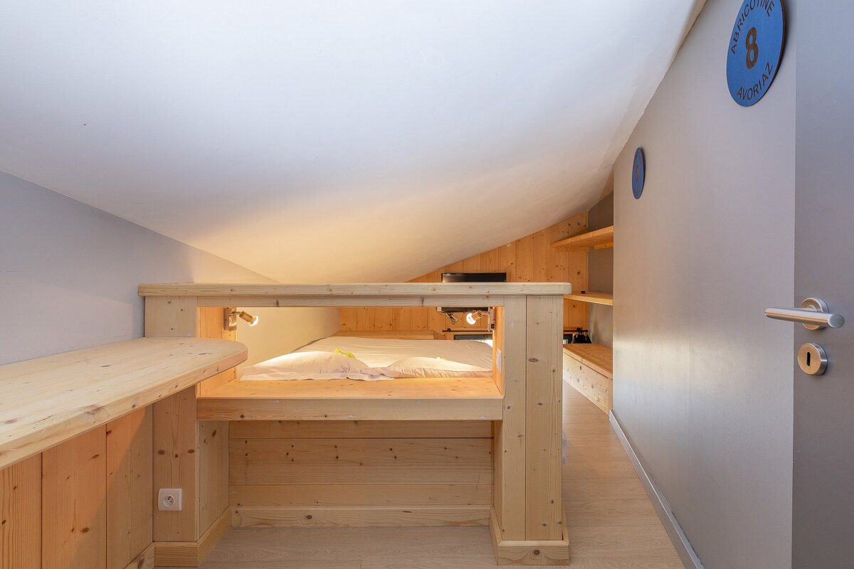 A bedroom with a blue sign on the wall that says 8