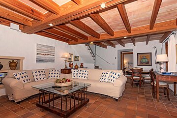 A living room with a couch and a glass coffee table
