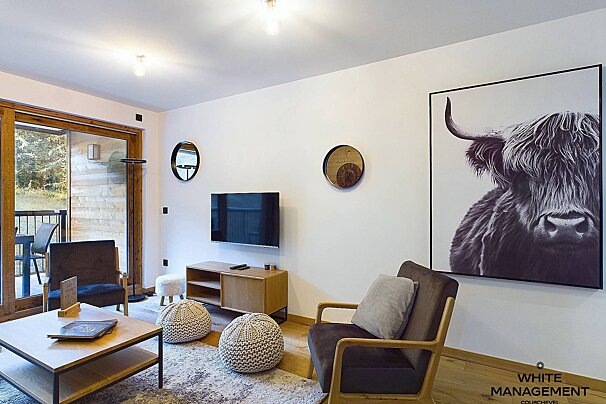 A living room with a picture of a yak on the wall