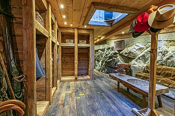 A wooden closet with a skylight above it