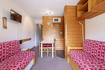 A living room with a couch a table and a microwave