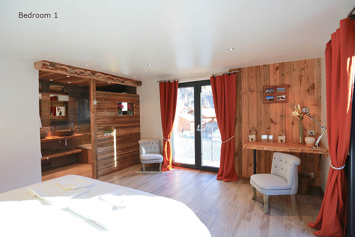 A bedroom with wooden walls and red curtains is labeled bedroom 1