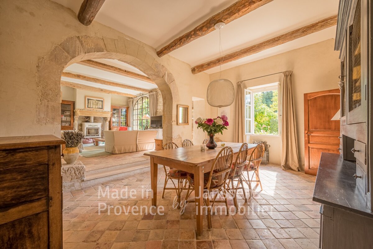 A dining room with a table and chairs and the words made in provence on the bottom
