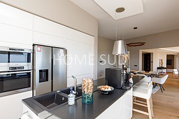 A kitchen with the word home on the wall