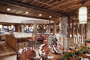 A dining room with cowhide chairs and candles on the table
