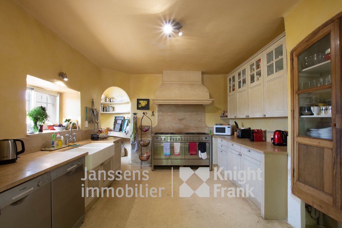 A kitchen with a sign that says janssens immobilier