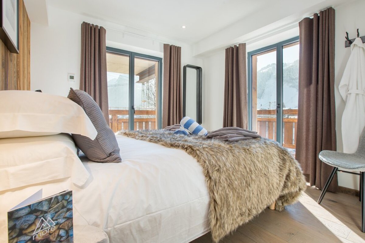 A bedroom with a bed and a book that says love on it