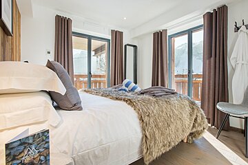 A bedroom with a bed and a book that says love on it