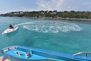 A man sits on a boat in a body of water