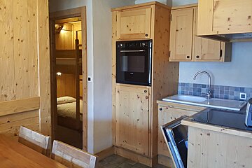 A kitchen with wooden cabinets and a siemens oven