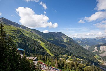 A view of a mountain range with a blue building in the foreground