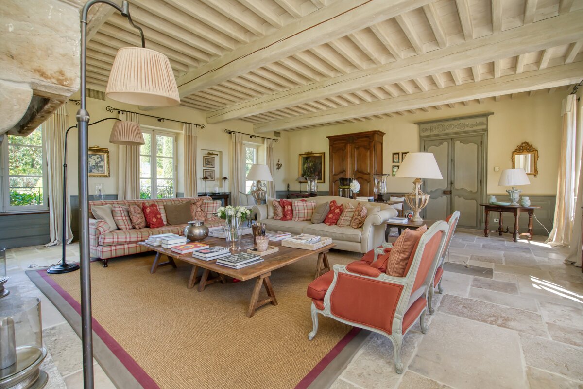 A living room filled with furniture including a couch and chairs