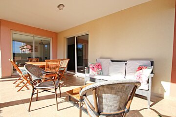 A patio with a table and chairs and a couch