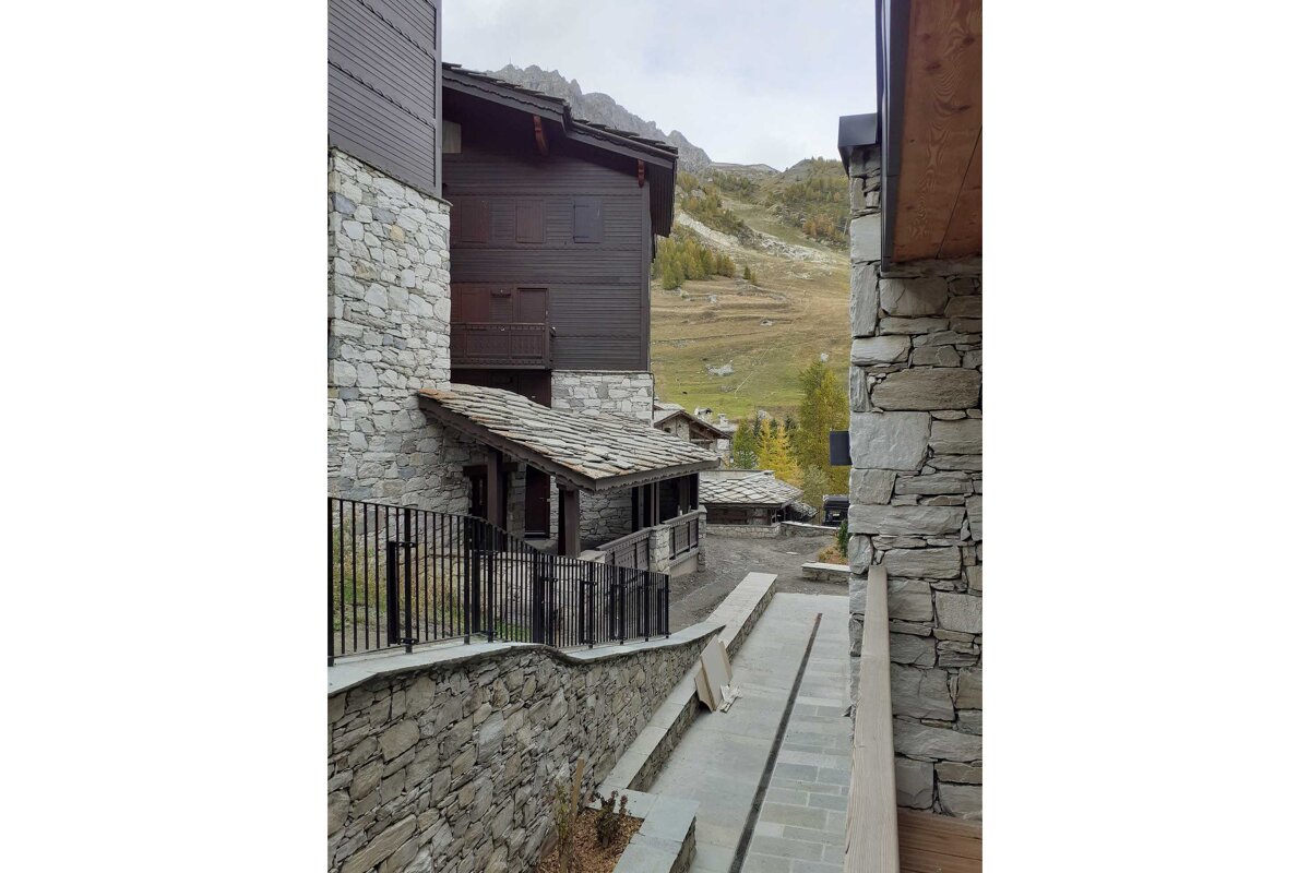 A bedroom with a bed and a bathroom behind it